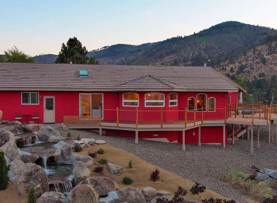 This stunning red house offers a unique blend of modern design and natural beauty.