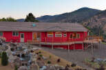 This stunning red house offers a unique blend of modern design and natural beauty.