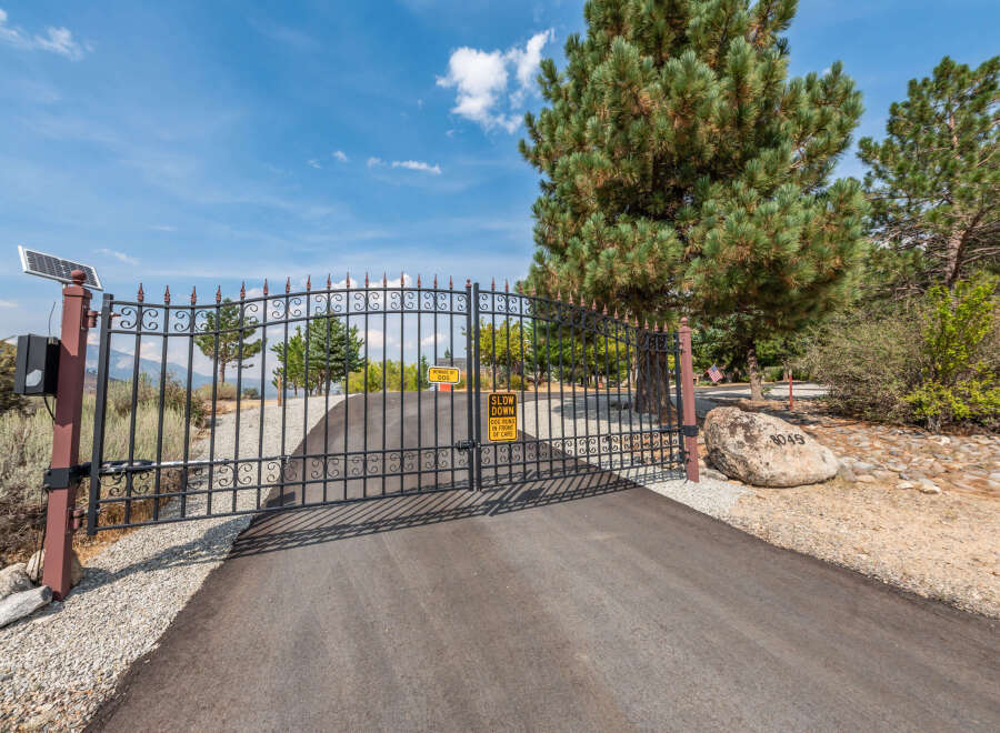 Discover the charm of this gated property, featuring a secure entrance and a welcoming driveway.