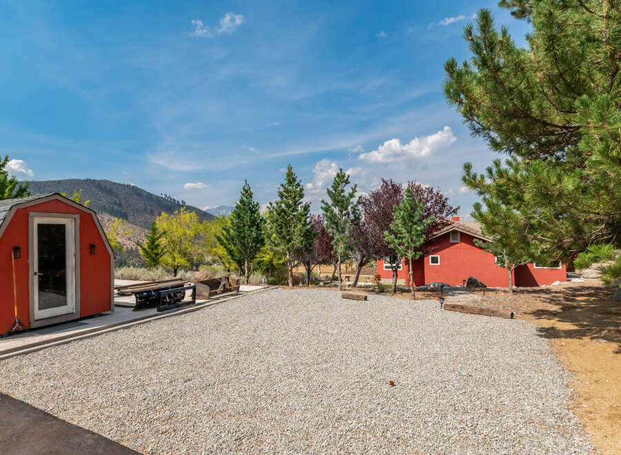 Discover your dream property! This charming home features a spacious gravel driveway, perfect for parking and outdoor activities.