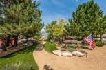 This stunning property boasts a beautifully landscaped yard with lush greenery and a winding pathway.