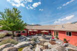This stunning property boasts a beautifully landscaped backyard with a serene water feature and lush greenery.