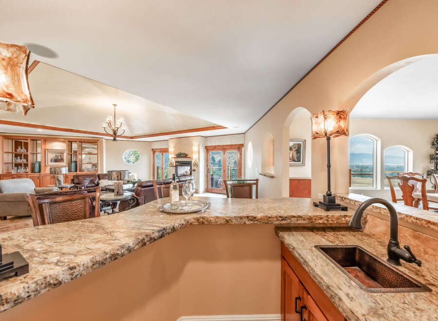 This stunning kitchen boasts a luxurious granite countertop, perfect for both meal preparation and entertaining.
