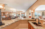 This stunning kitchen boasts a luxurious granite countertop, perfect for both meal preparation and entertaining.