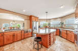 This stunning kitchen boasts a spacious layout with beautiful wooden cabinetry and granite countertops, perfect for both cooking and entertaining.