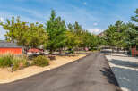 Discover the charm of this stunning property, featuring a winding asphalt driveway that leads to a picturesque setting.