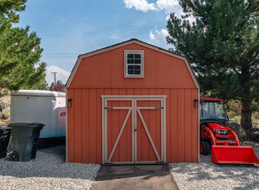 This charming property features a well-maintained shed with a classic barn-style design, perfect for storage or a workshop.
