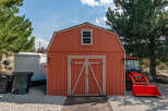 This charming property features a well-maintained shed with a classic barn-style design, perfect for storage or a workshop.