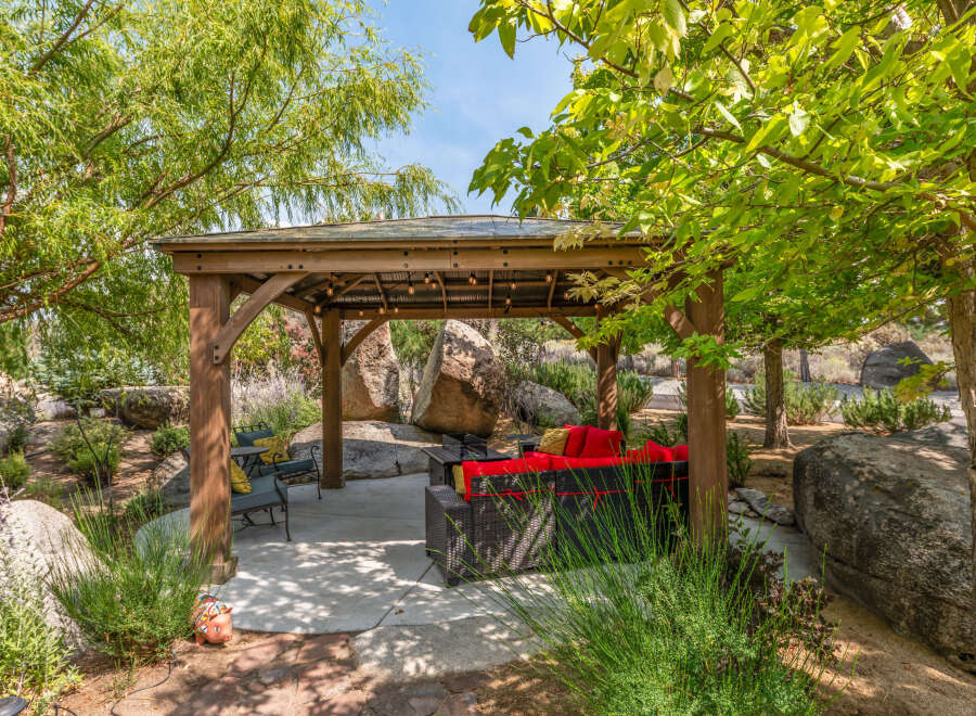 Enjoy the tranquility of this outdoor oasis, featuring a charming gazebo with comfortable seating.