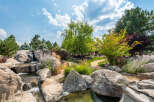 Discover a serene oasis in this stunning property, featuring a beautifully designed water feature with cascading waterfalls and natural rock formations.