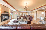 Step into luxury with this stunning living room, featuring a cozy fireplace and elegant leather seating.