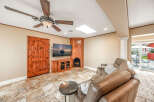This stunning property boasts a cozy living room with a fireplace and a large-screen TV, perfect for relaxing evenings.