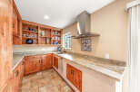 This stunning kitchen boasts custom wooden cabinetry and granite countertops, offering both style and functionality.