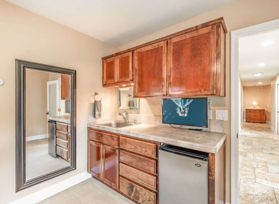 This stunning property boasts a beautifully designed wet bar, perfect for entertaining guests.