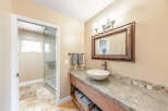 This beautiful bathroom features a stylish vanity with a vessel sink and a large mirror.