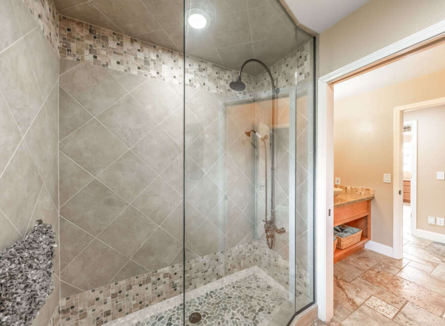 Step into luxury with this stunning bathroom featuring a glass-enclosed shower.