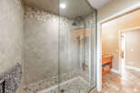 Step into luxury with this stunning bathroom featuring a glass-enclosed shower.