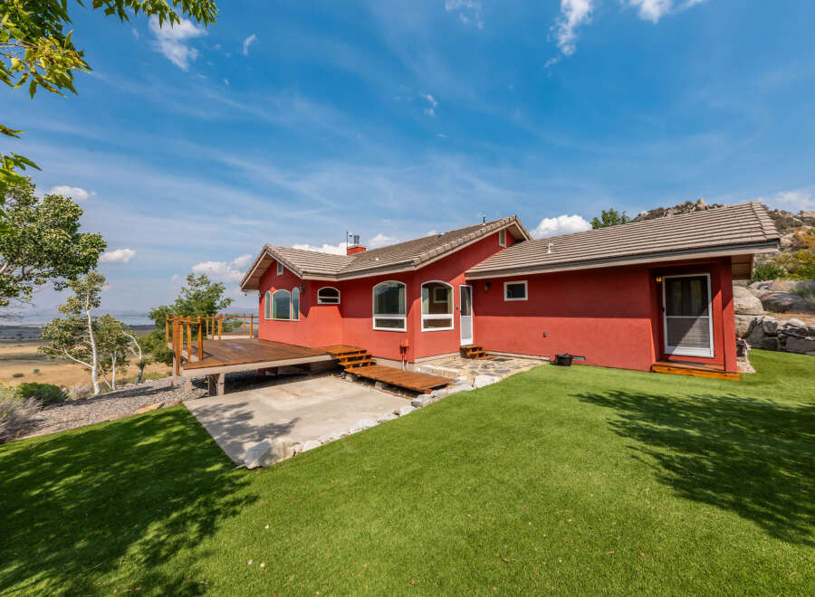 This stunning property boasts a vibrant red exterior, creating a striking visual appeal.