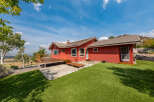 This stunning property boasts a vibrant red exterior, creating a striking visual appeal.