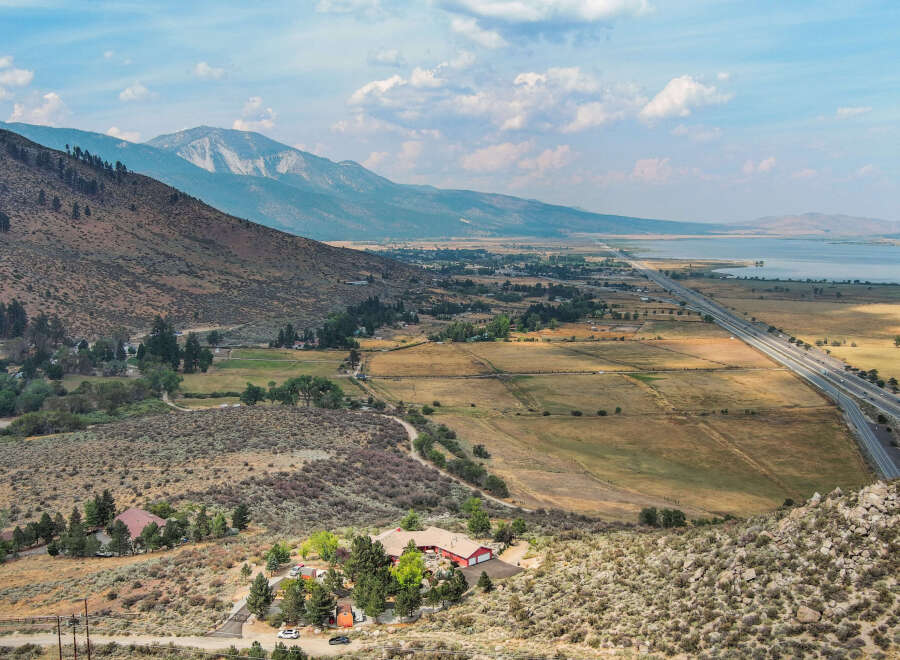 Discover a stunning property nestled in a picturesque landscape, offering breathtaking views of the surrounding mountains and a serene lake.