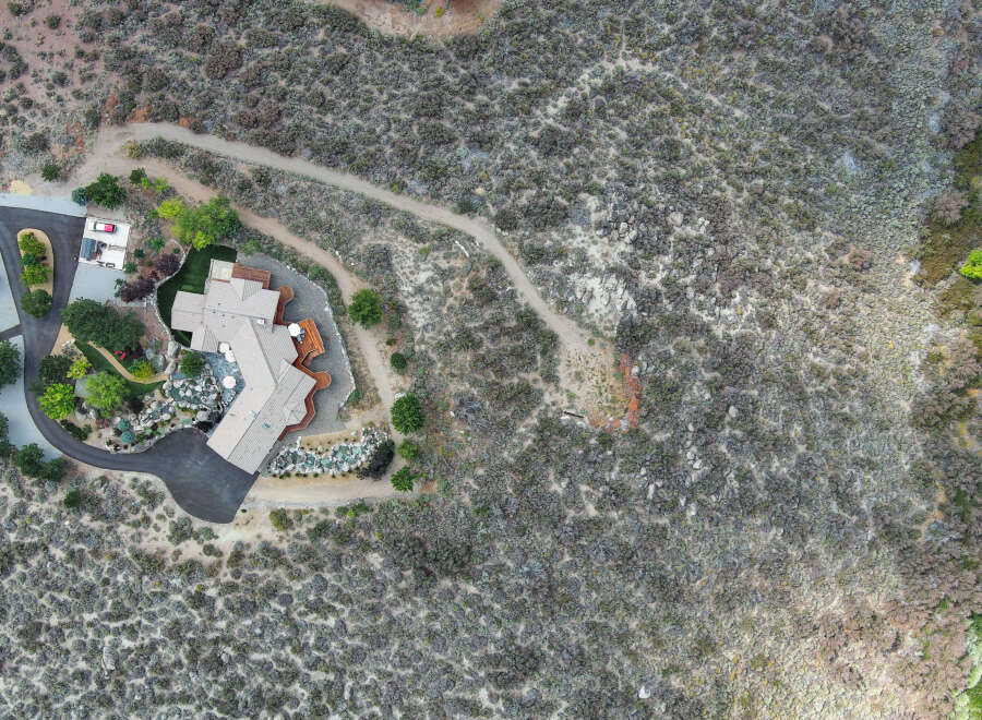 This stunning property boasts a unique architectural design, seamlessly blending with its natural surroundings.
