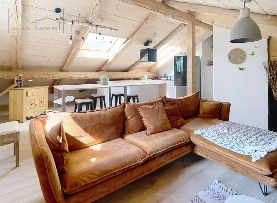 Discover the charm of this stunning property, featuring a spacious living area with a cozy brown sofa and a modern kitchen.