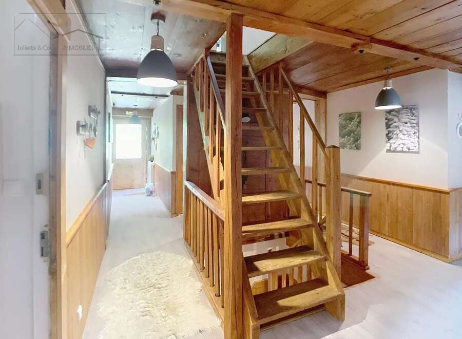 Discover the charm of this inviting property, featuring a beautifully crafted wooden staircase that adds character and warmth.