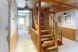 Discover the charm of this inviting property, featuring a beautifully crafted wooden staircase that adds character and warmth.