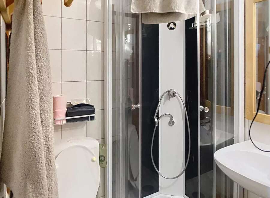 Step into this charming bathroom featuring a modern shower enclosure and a convenient toilet.