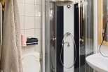 Step into this charming bathroom featuring a modern shower enclosure and a convenient toilet.