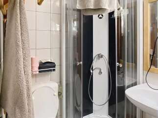Step into this charming bathroom featuring a modern shower enclosure and a convenient toilet.