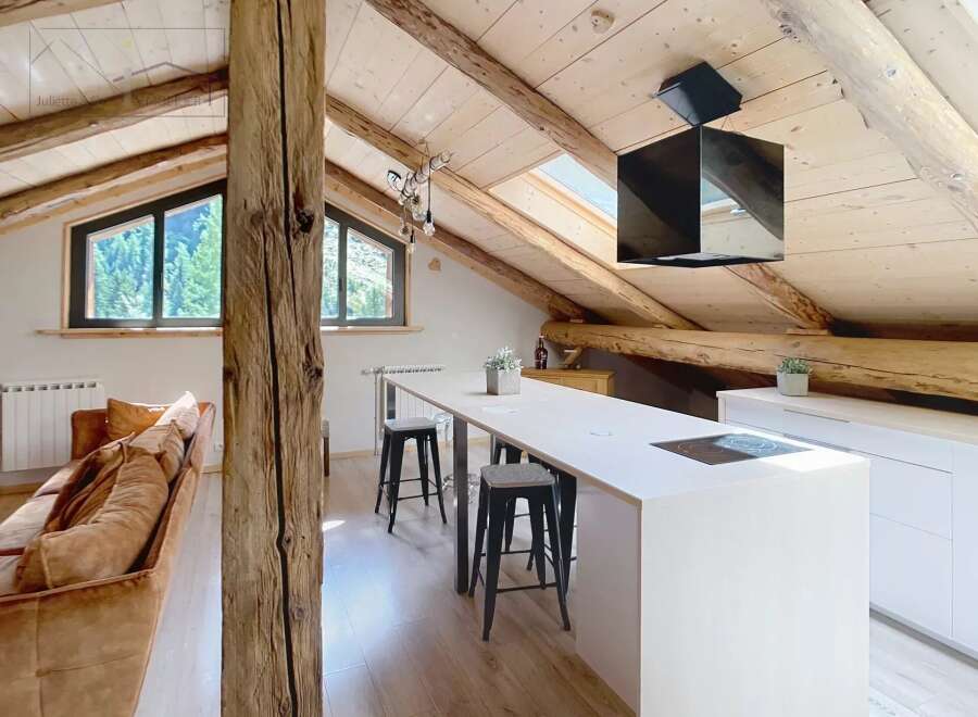 Discover the charm of this stunning property, featuring a modern kitchen with sleek white cabinetry and a stylish island.