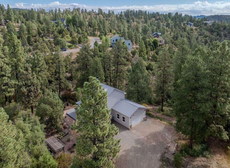 Nestled amidst a lush forest, this stunning property offers a serene escape.