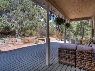 Enjoy the tranquility of this beautiful outdoor space! This property features a spacious deck, perfect for entertaining or relaxing.