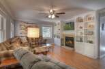 Step into luxury with this stunning living room, featuring a cozy fireplace and built-in shelving.