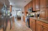 Step into this inviting kitchen, featuring warm wooden cabinetry and sleek stainless steel appliances.