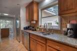 This beautiful kitchen boasts stunning granite countertops and warm wooden cabinetry, creating an inviting and functional space.