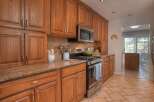 This beautiful kitchen boasts custom cabinetry, offering ample storage and a warm, inviting atmosphere.