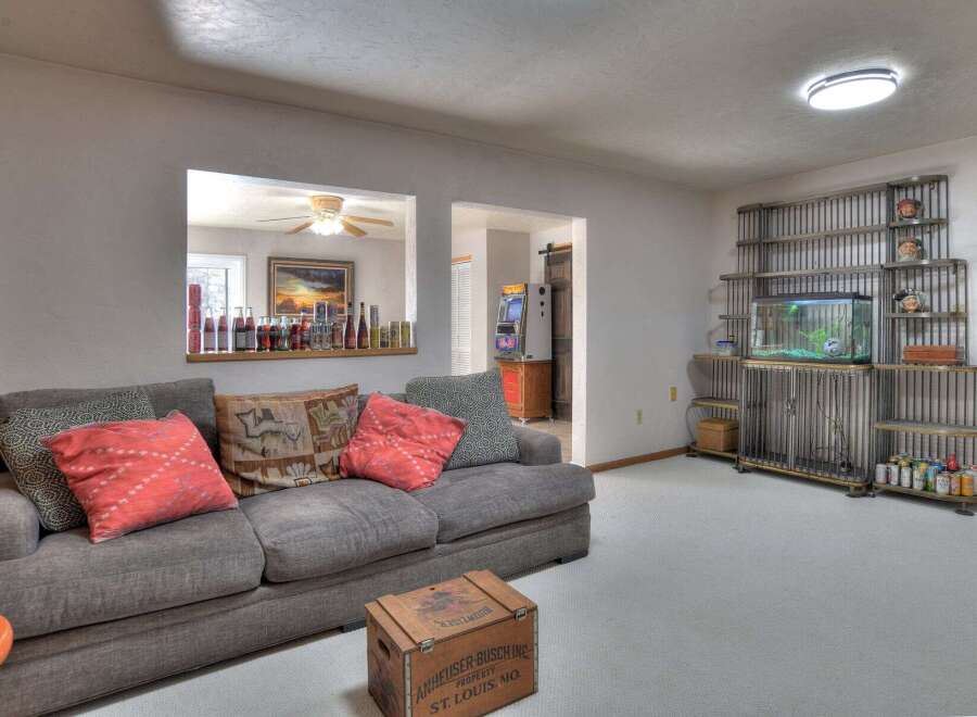 This inviting living space features a cozy gray sofa adorned with decorative pillows, perfect for relaxation.