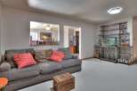 This inviting living space features a cozy gray sofa adorned with decorative pillows, perfect for relaxation.