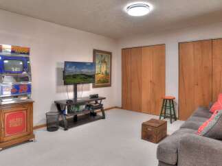 This cozy living space features a unique vintage slot machine, adding a touch of retro charm.