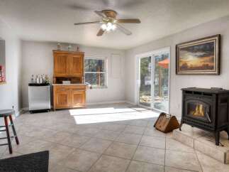 Step into this inviting living space, featuring a cozy fireplace and ample natural light.