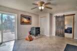Step into this inviting living space, featuring a cozy fireplace and a rustic sliding barn door.