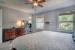 This inviting bedroom offers a serene retreat with its soft color palette and ample natural light.