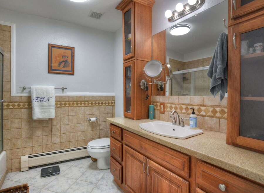 This inviting bathroom features a stylish vanity with ample storage and a sleek sink.