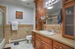 This inviting bathroom features a stylish vanity with ample storage and a sleek sink.