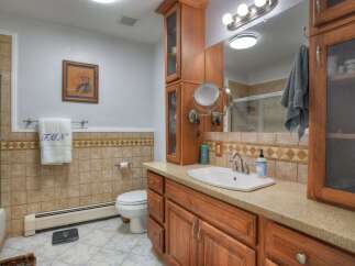 This inviting bathroom features a stylish vanity with ample storage and a sleek sink.