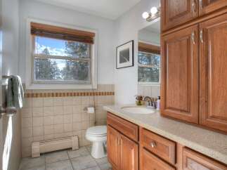 This beautiful bathroom features a bright and airy atmosphere with a large window that offers stunning views of the outdoors.