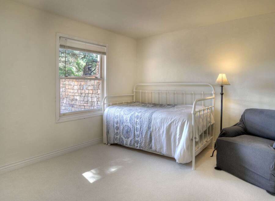 This charming bedroom features a cozy daybed, perfect for relaxing or accommodating guests.