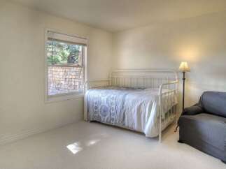 This charming bedroom features a cozy daybed, perfect for relaxing or accommodating guests.